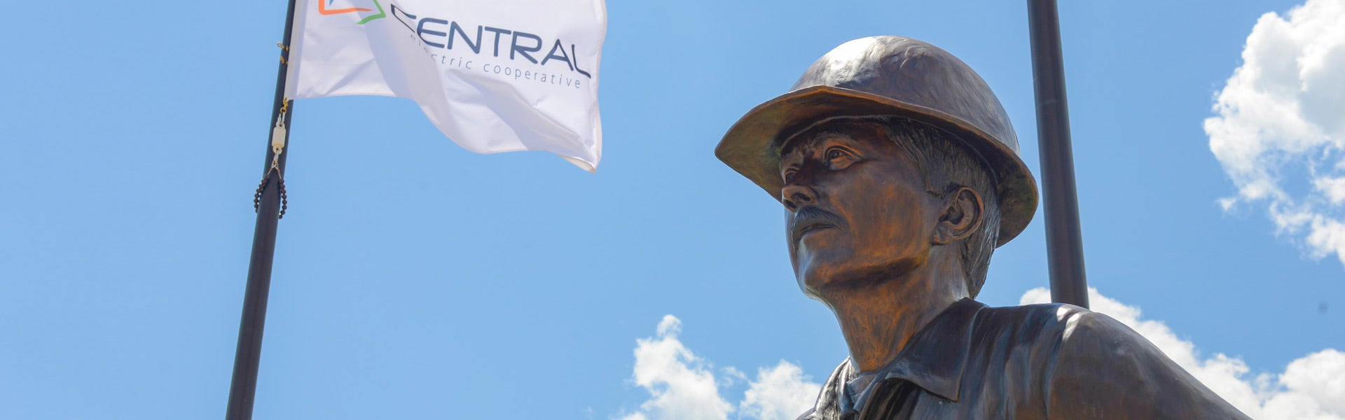 Photo of lineman statue with Central flag in the background