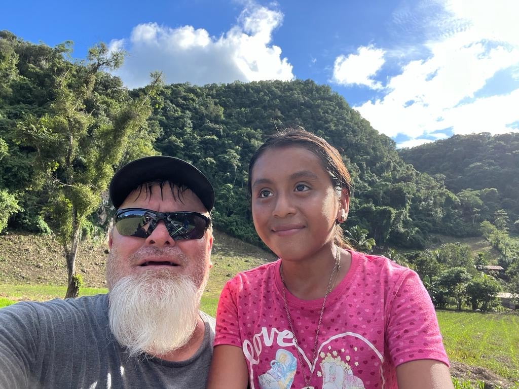 Lineman, Jerry Cundiff, with Guatemala native.