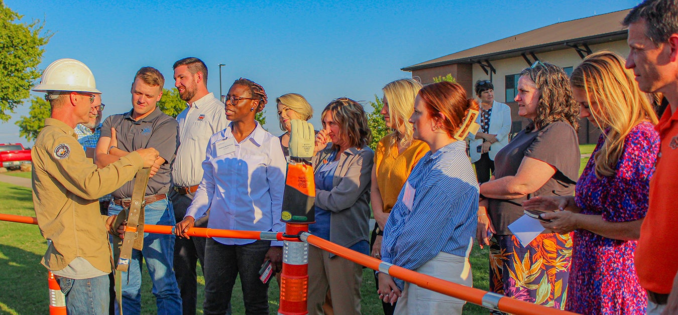 Central lineman teaching group about electrical safety